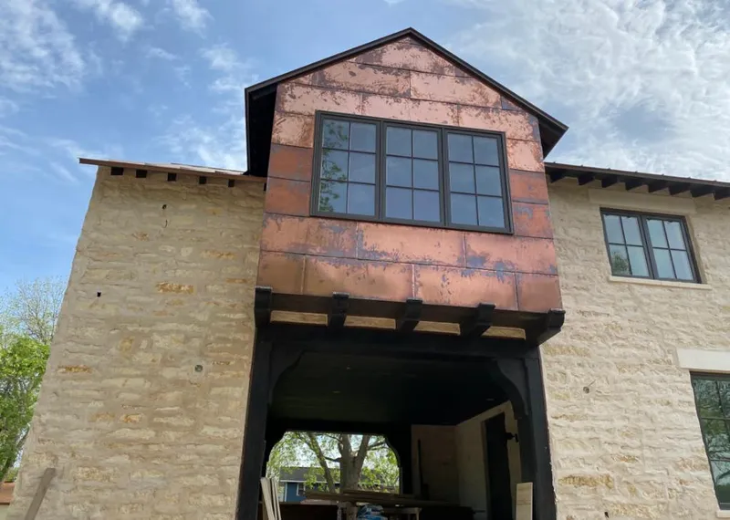 Copper metal panel facade on a stone building for Skylight Installation in Cromwell